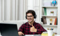 student-online-cute-guy-checked-shirt-with-glasses-studying-computer-showing-good-gesture