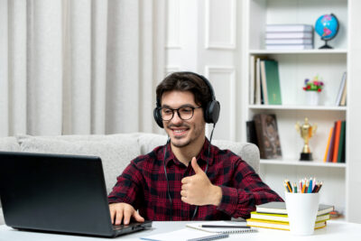 student-online-cute-guy-checked-shirt-with-glasses-studying-computer-showing-good-gesture