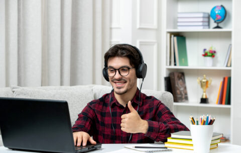 student-online-cute-guy-checked-shirt-with-glasses-studying-computer-showing-good-gesture